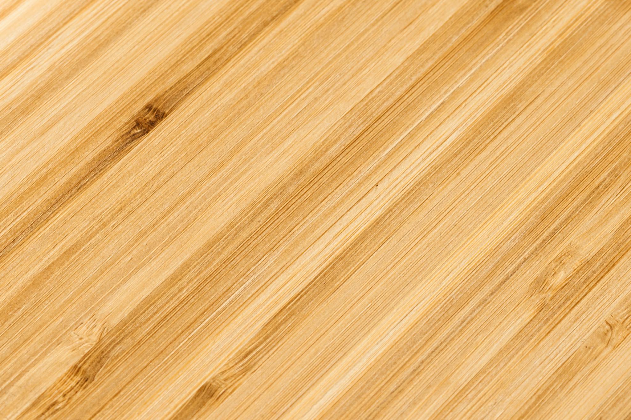 Close-up of bamboo wood texture with natural grain and warm tones, ideal for backgrounds.