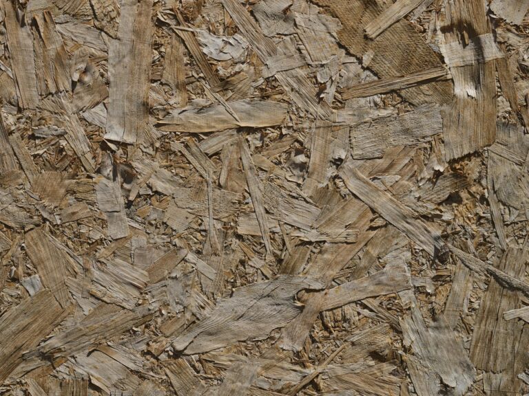 Detailed close-up of a textured OSB wood surface showcasing patterns and natural hues.