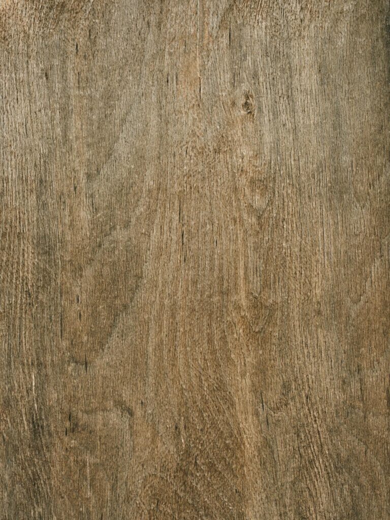 Detailed close-up of smooth brown wood grain texture for backgrounds and material designs.